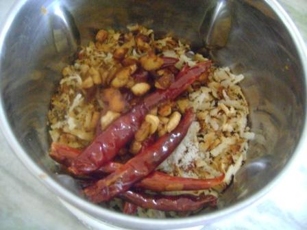 Add roasted Coconut, Salt, Garlic & Red Chilies to the grinder